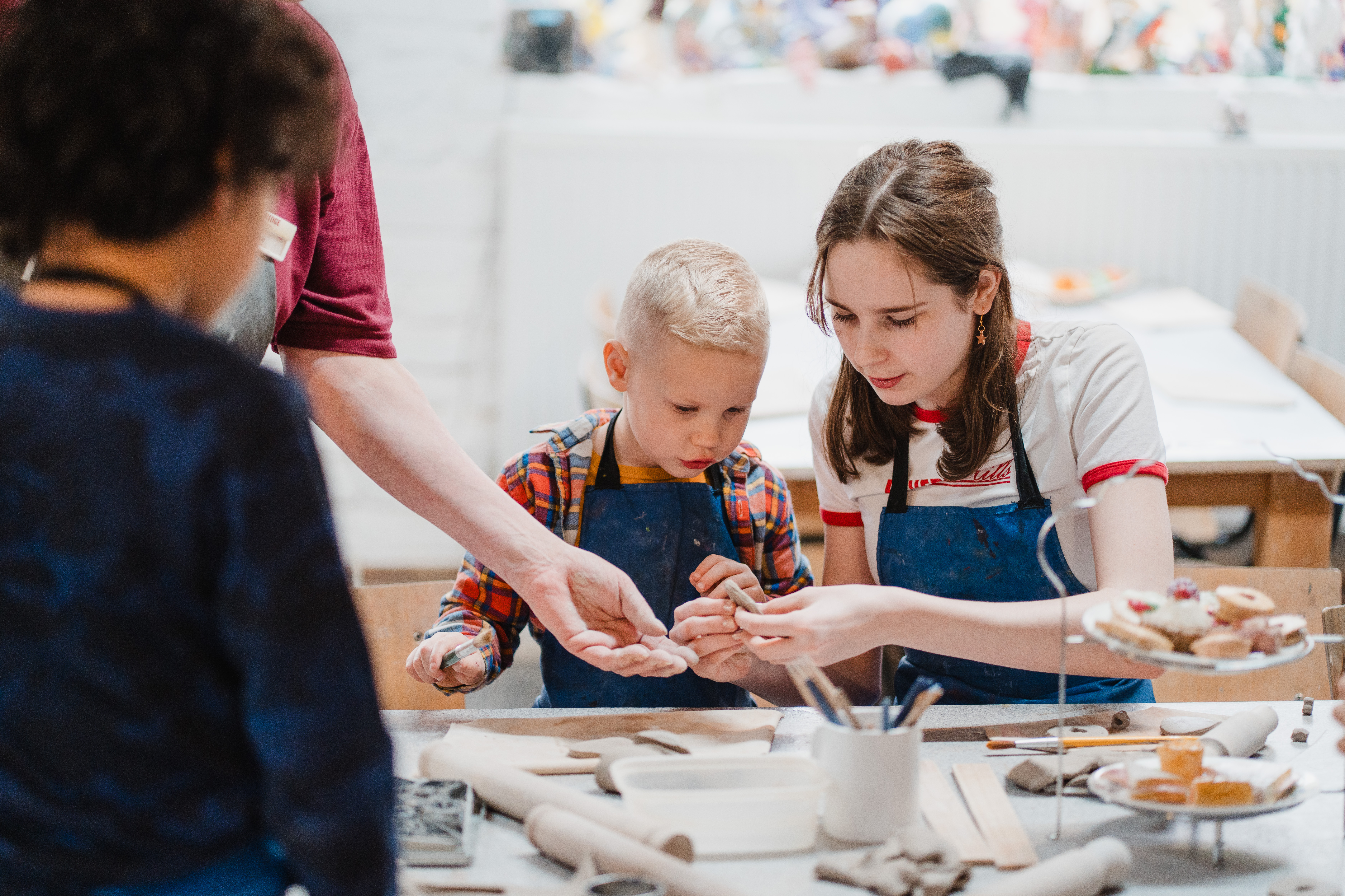 Two children making shapes from clay
